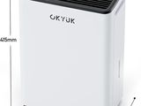 a white air conditioner sitting on top of a white table