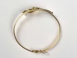 a close up of a gold bracelet with a snake on it