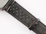 a close up of a watch on a white surface