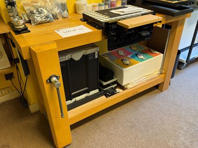 a desk with a printer, printer, and other items on it