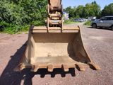 a bulldozer that is sitting in the middle of a parking lot