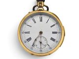 a gold pocket watch with roman numerals on the face