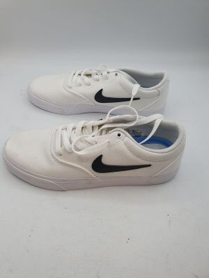 white and black nike sneakers on a white surface