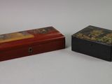 two small boxes sitting next to each other on a table