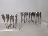 a lot of silver spoons sitting on a clear stand