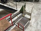 a cart with two seats and a hand truck in the background