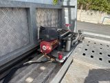 a red fire hydrant sitting on the back of a truck
