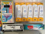 a lot of pens, markers, markers, and markers on the table