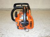 a chainsaw on the floor with a keychain attached to it