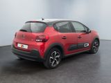 the rear view of a red citrole car parked in a room