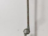 a metal object with a wooden handle on a white background