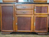 a wooden cabinet with a mirror on top of it