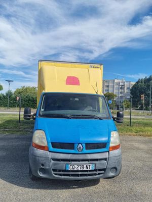 a blue van parked in a parking lot with a yellow box on the back of it