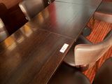 a long table with many chairs around it in a room