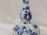 a blue and white vase sitting on a white surface