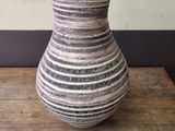 a vase that is sitting on a wooden table
