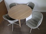 a table with four chairs around it in a room