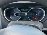 a steering wheel and dashboard of a car with a clock on it