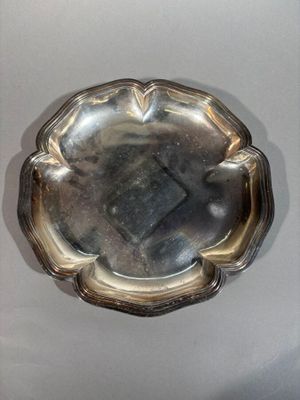 a silver plate with a flower design on it