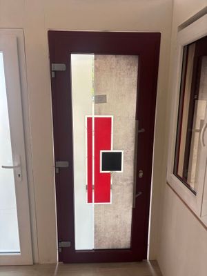 a glass door with a red and white design on it