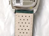 a close up of a watch on a white surface