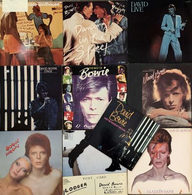 many different album covers on the table together