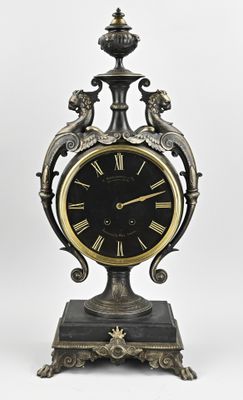 a clock that is sitting on a stand on a white background