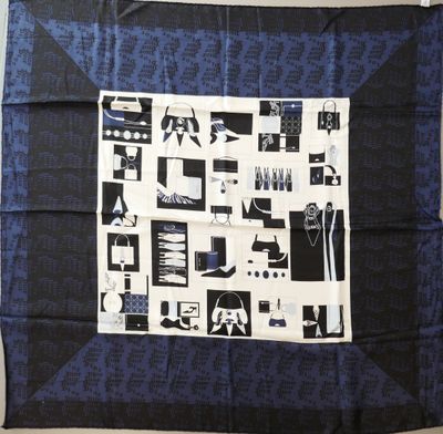 an image of a blue and black scarf with black and white images on it