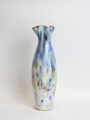 a blue and white vase sitting on a white surface
