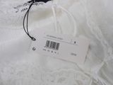 the label is on a white dress with a black and white design