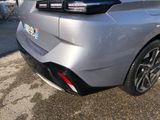 the rear end of a silver car parked in a parking lot
