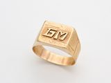 a gold signet ring with the word yes on it