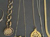 several different types of necklaces and bracelets on a table