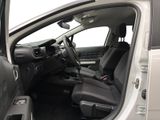 the interior of a car with the door open and the driver ' s seat down
