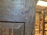 a wooden door in the middle of a room with many pieces of luggage