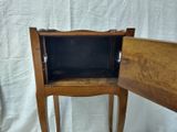 a small wooden table with a drawer on it