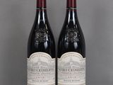 two bottles of red wine sitting on top of a glass table