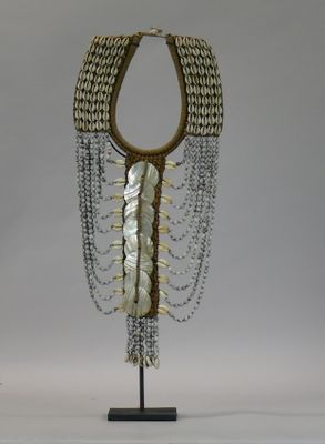 an image of a necklace made of shells and chains