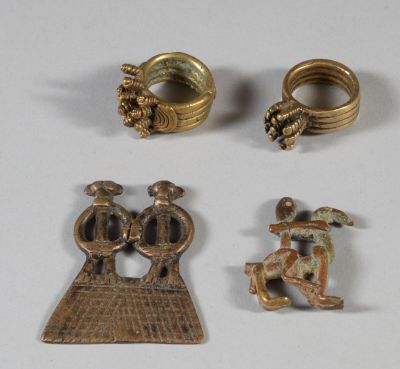 three gold rings and a ring with a bird on top of it