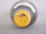 a close up view of a yellow bottle with a hole in it
