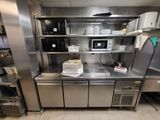 a large stainless steel kitchen with a lot of counter space