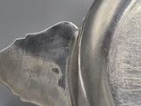 a close up of a silver object on a table