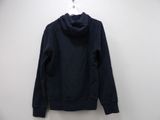 a black sweatshirt hanging on a white wall next to a hanger