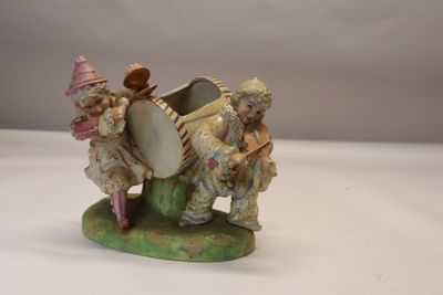 a figurine of two people sitting on a boat