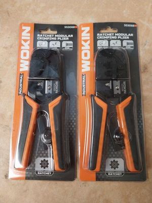 two pliers are sitting on top of each other on a table