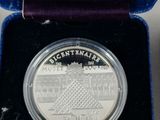 a close up of a silver coin in a purple box