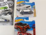 five hot wheels cars in the package on the table