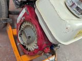a small engine on the back of a small motor bike
