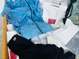 a wooden box filled with clothes and clothing on the floor