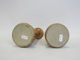 pair of antique stoneware candlesticks in the shape of a man and woman